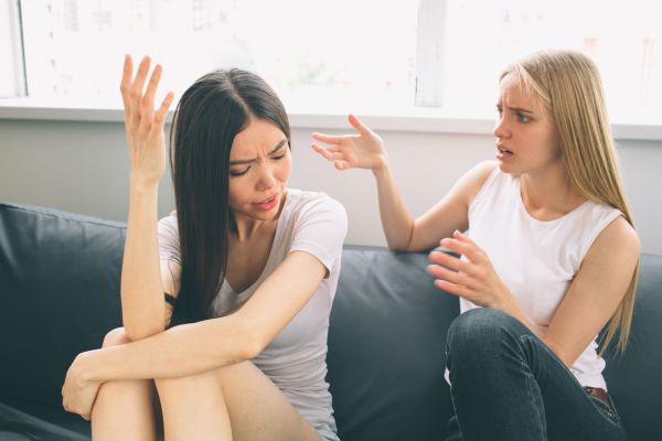 girls quarrel talking loudly about something annoyed