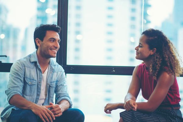 two people talking problems flaws smiling near the window
