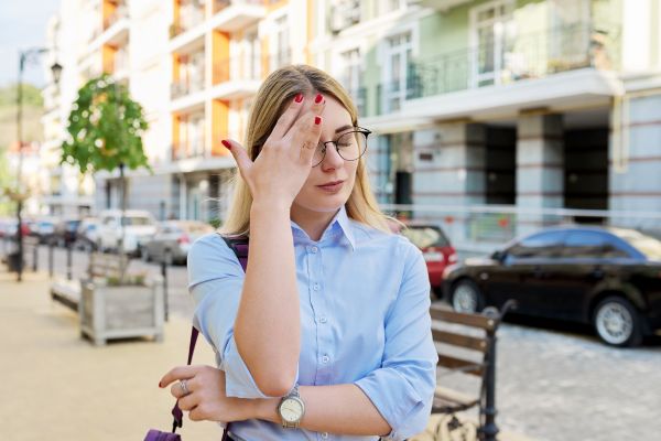 worried insecure serious young woman on city streets