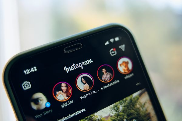 Instagram App Logo on Smartphone showing following profiles