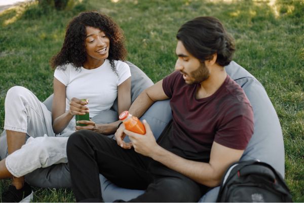 friend asks girl personal matters in garden sofa